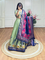 Pista green and blue color dola silk lehenga with foil and patola printed work