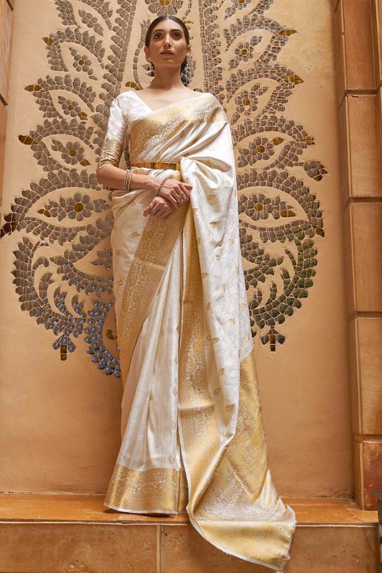 Off white soft banarasi silk saree with zari weaving work