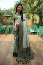 Sea green color kanjivaram silk saree with zari weaving work