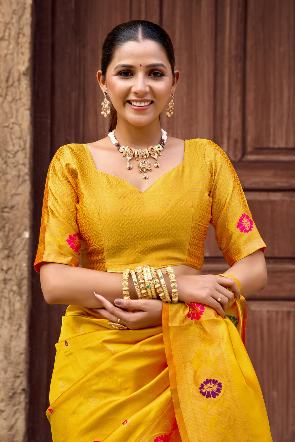 Traditional yellow paithani silk saree with zari weaving work