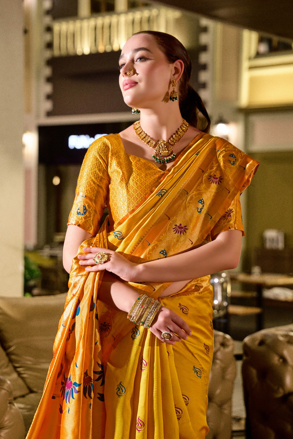 Traditional yellow paithani silk saree with zari weaving work