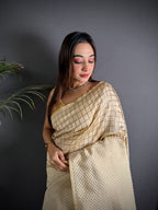 Off white color banarasi silk saree with zari weaving work